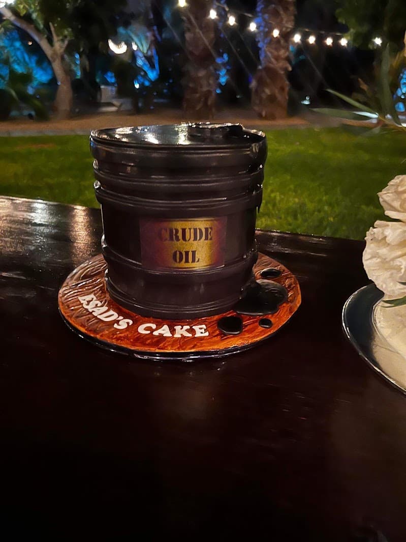 A wedding groom’s cake shaped like a barrel labeled Crude Oil